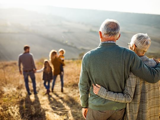 extended family with grandparents, parents and foster children enjoying the local countryside