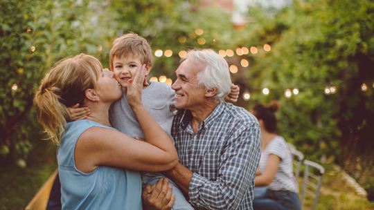 Foster parents and foster child at a garden party