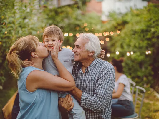 Foster parents and foster child at a garden party