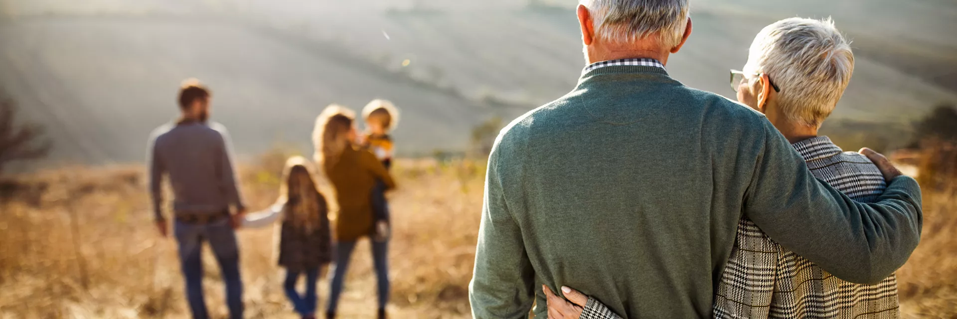 extended family with grandparents, parents and foster children enjoying the local countryside