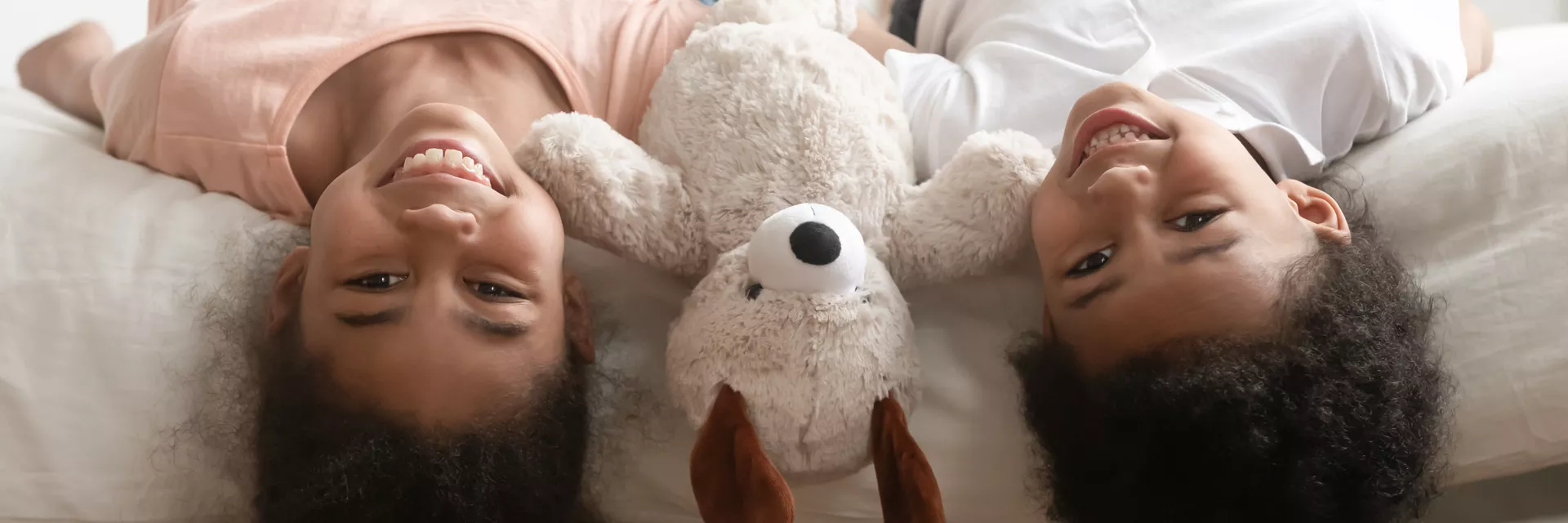 the importance of foster children having their own room. image: two children with a teddy in a bedroom